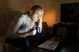 man in dark room with computer