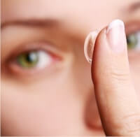 Woman putting in contact lens