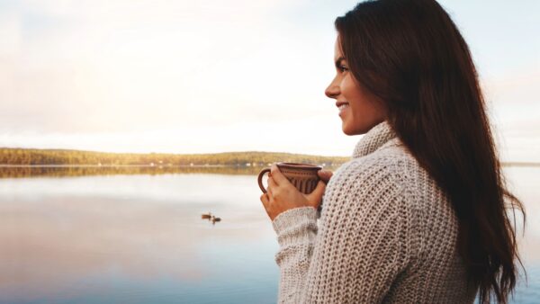 Woman at lake with coffee