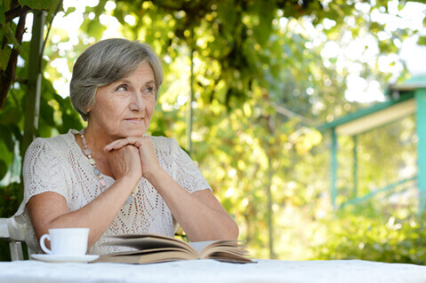 Middle aged woman outdoors drinking tea