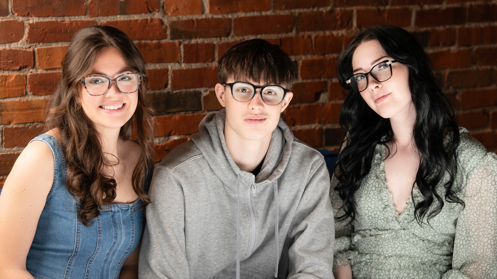 three young people in glasses
