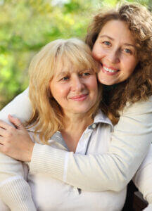 Daughter hugging her mother from behind