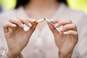 Woman breaking a cigarette