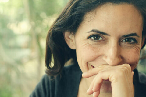 Beautiful middle-aged woman with hand over mouth