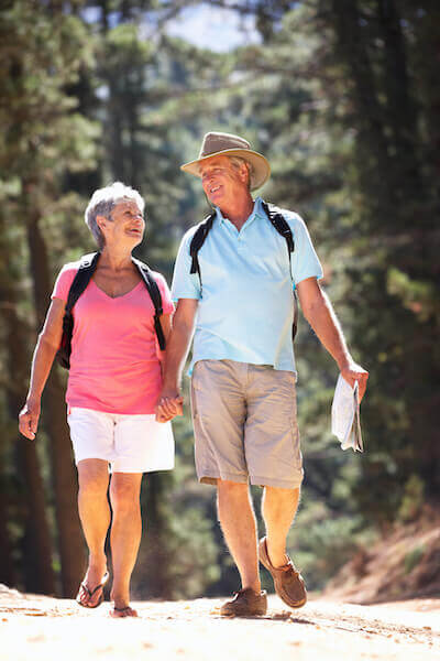 Happy mature couple hiking in summer