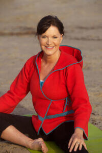 Woman doing yoga on beach